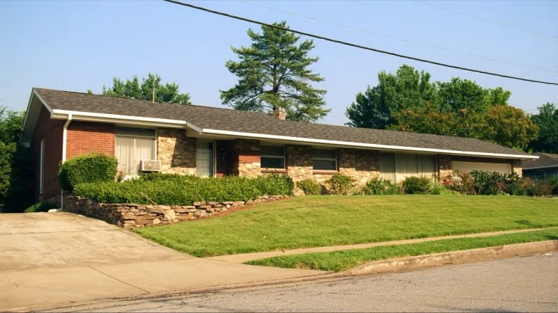 Brick ranch with stone accents and freshly installed white seamless gutters — Austell, GA