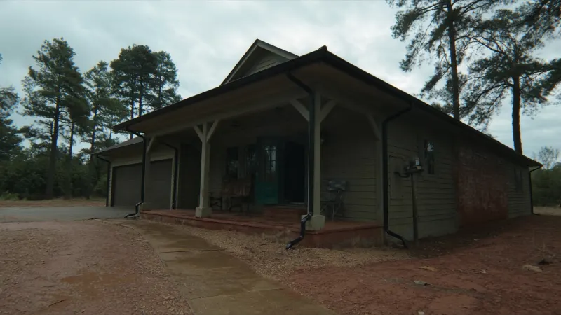 Craftsman home on a red-clay Paulding County lot with black seamless gutters and extended downspouts — Dallas, GA