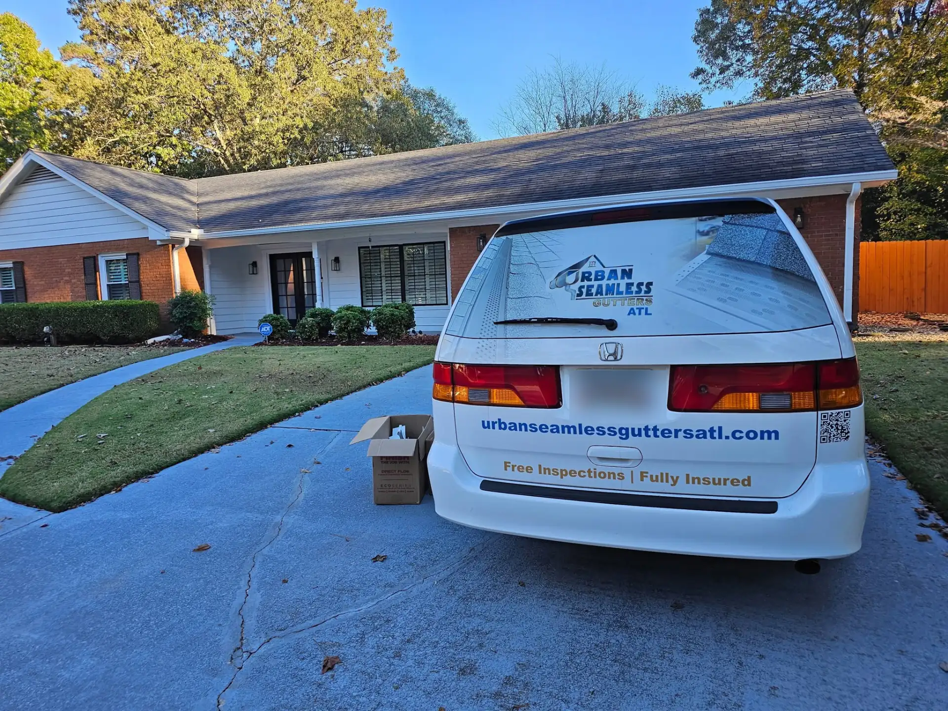 Gutter company service van parked at a Douglasville, GA home following a full seamless gutter installation in Douglas County