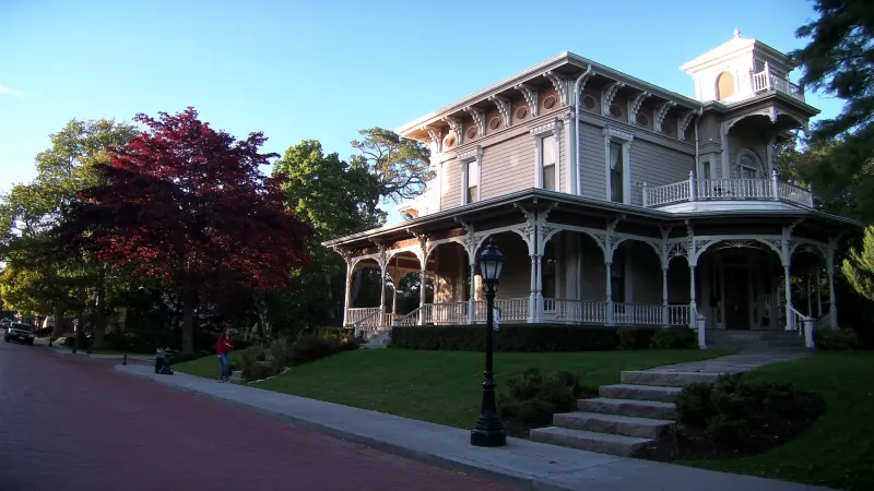 Restored Victorian near historic downtown Douglasville with white seamless gutters on a steep ornate roofline — Douglasville, GA