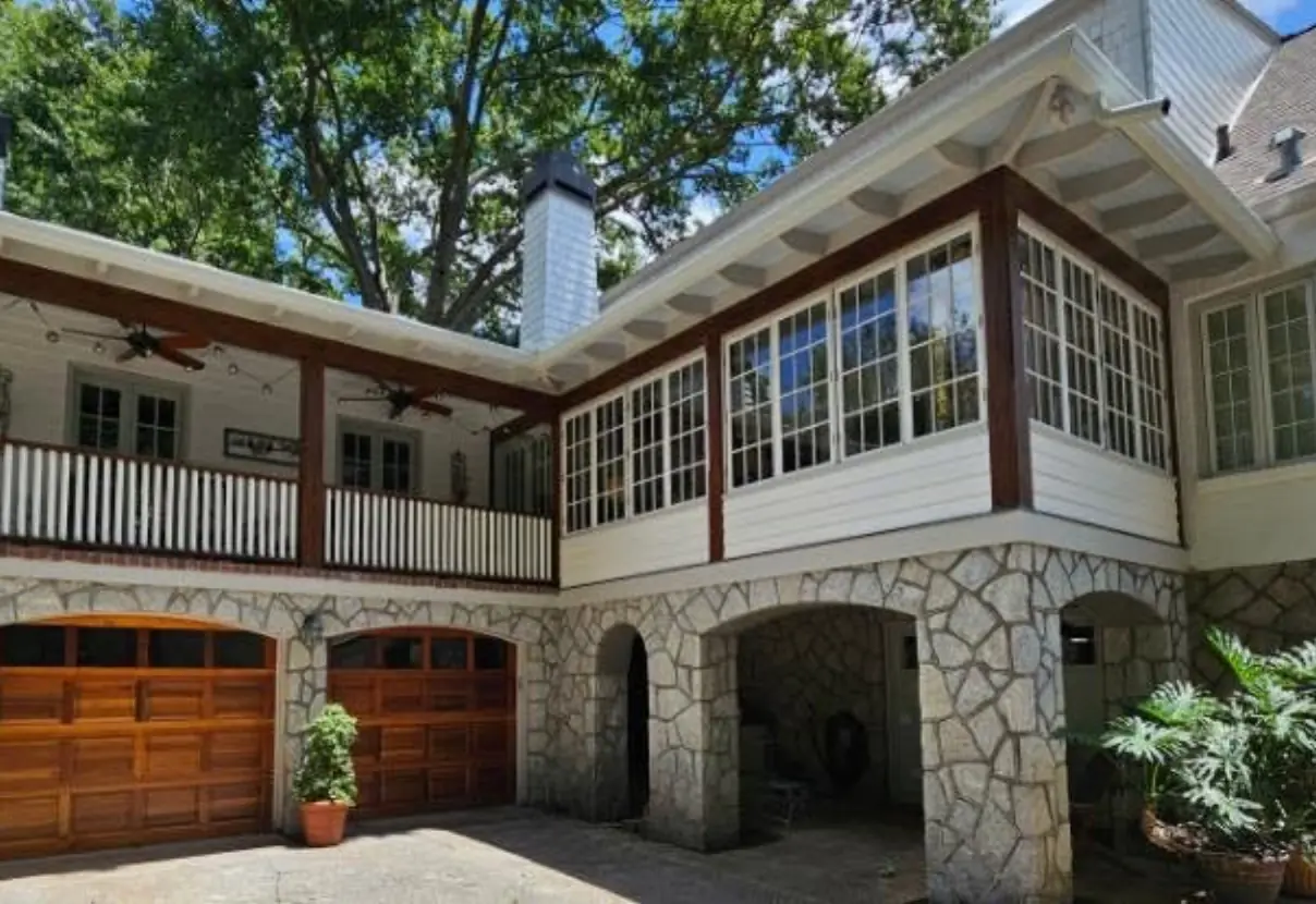 Seamless replacement gutters along the sunroom and porch rooflines of a Duluth, GA home