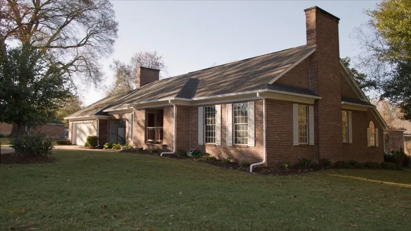 Renovated 1970s colonial with bright white seamless gutters in a Perimeter-area Dunwoody neighborhood — Dunwoody, GA