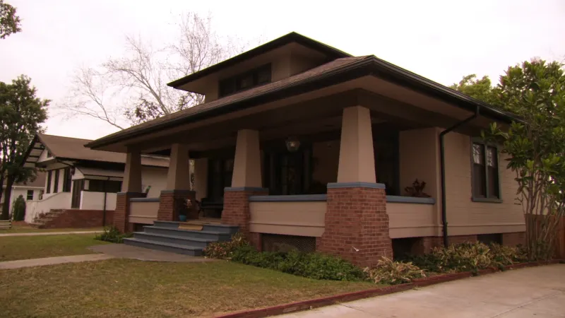1920s craftsman bungalow with new black seamless gutters in East Point's historic Tri-Cities area — East Point, GA