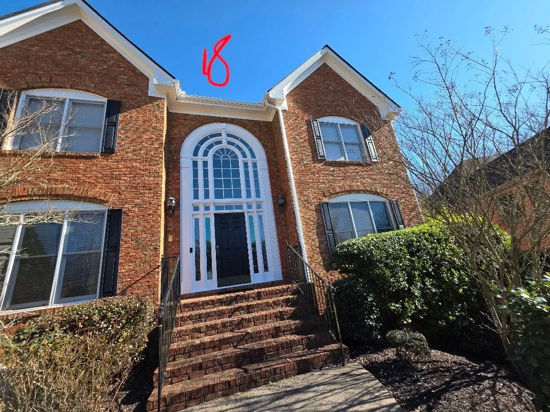Estimate photo of the front entry with the gutter run length marked in red, from measuring the job in Alpharetta, GA