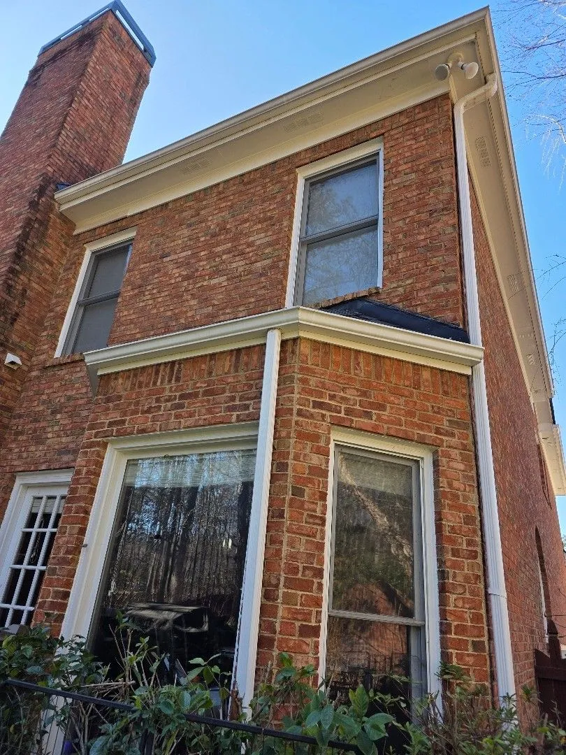 Rear bay window with a short gutter run and downspouts below a second-story gutter, on an Alpharetta, GA home