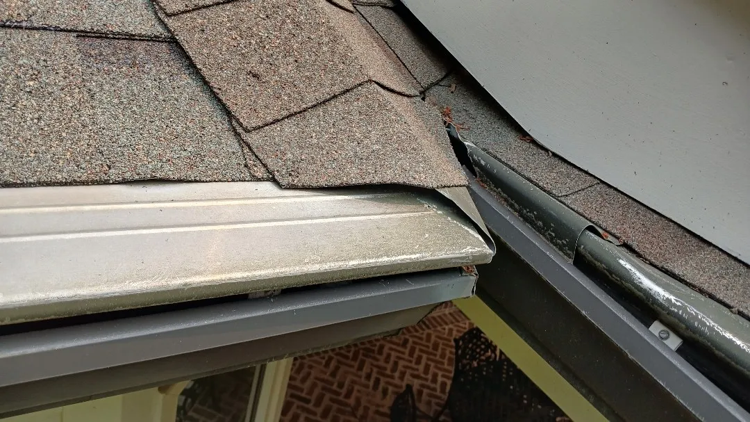 Gutter guards along the roof edge where two gutter runs meet at a corner, on an Alpharetta, GA home