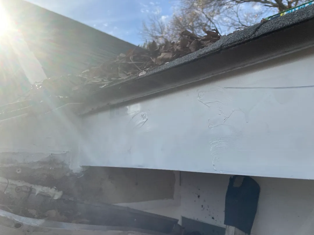 After: the same fascia replaced and painted white under the shingle roof edge at an Atlanta, GA townhome