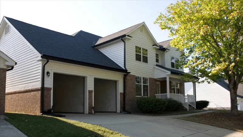 Well-kept Clayton County two-story with continuous black seamless gutter runs — Jonesboro, GA