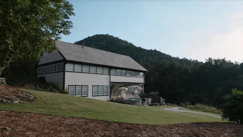Two-story Kennesaw home with black seamless gutters and Kennesaw Mountain rising in the background — Kennesaw, GA