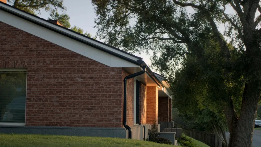 Well-kept brick home with granite stone details and black seamless gutters — Lithonia, GA
