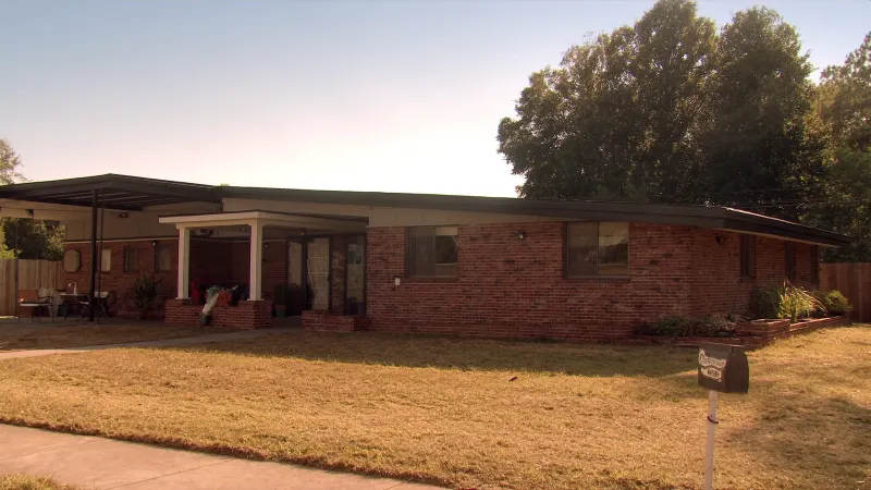 Mid-century brick ranch with full-length black seamless gutter runs — Tucker, GA