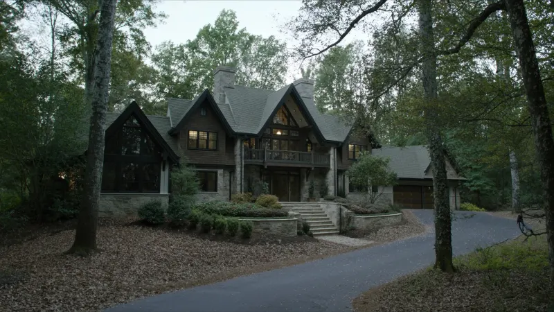 Wooded-lot Vinings estate with matte black seamless gutters on a complex roofline — Vinings, GA